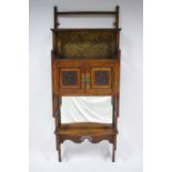 A VICTORIAN WALNUT AESTHETIC STYLE WALL CABINET in the style of E. W. Godwin, enclosed by pair of