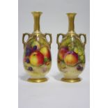 A PAIR OF ROYAL WORCESTER PORCELAIN SLENDER OVOID TWO-HANDLED VASES with narrow necks, the bodies