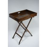 A 19th century oak rectangular butler’s tray, 27½” x 17½”; on folding trestle stand.