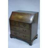 An 18th century style mahogany bureau with marquetry shell motif to the sloping fall front, fitted