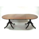 A regency mahogany dining table having two D-shaped ends, each on ring-turned pedestal & four