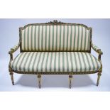A 19th century carved giltwood frame sofa in the Louis XVI style, having floral & leaf-scroll