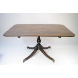 A late 18th century mahogany breakfast table, the rectangular tilt-top on slender baluster-turned