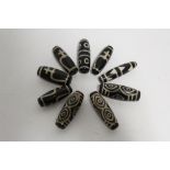 Nine Tibetan Tian Chu black & white hardstone beads of elongated form, each approx. 1½” long.