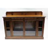 A Victorian walnut side cabinet by HOWARD & SONS, Berners St., London, fitted four frieze drawers