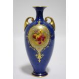 A Royal Worcester porcelain slender ovoid two-handled vase of powdered blue ground, with finely