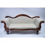 An early Victorian figured mahogany scroll-end sofa with upholstered arched back, arms, & seat, & on