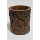 A Chinese bamboo cylindrical brush pot, the exterior intricately carved all-over with an elephant