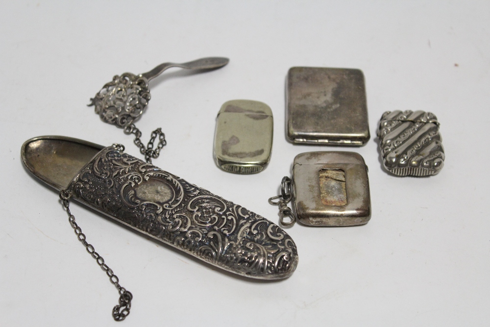 An embossed oblong scissors sheath with belt clasp & chain; an Edwardian vesta case with striking