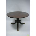 A regency mahogany breakfast table having circular tilt-top, on spiral-fluted centre column &