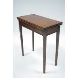 A late 18th century mahogany small rectangular tea table with fold-over top, on square tapered legs;