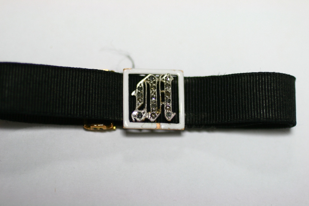 A gold, white enamel, & woven black silk adjustable bracelet, the square open-work panel centred - Image 2 of 5