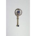 An early 20th century bar brooch set oval sapphire to one end, the other end with large open-work