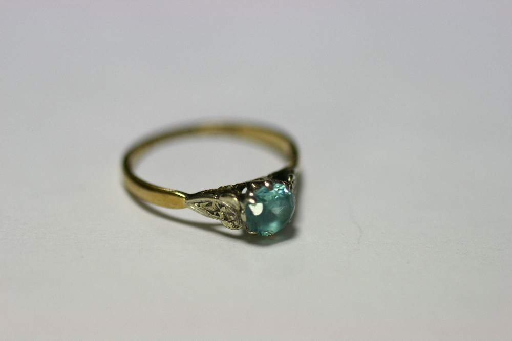 A 9ct gold ring set aquamarine (London 1950); a 9ct gold ring set three graduated garnets; five