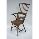 A 19th century beech & elm comb-back Windsor elbow chair with hard seat & on turned legs.