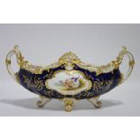 An early 20th century Coalport porcelain narrow oval two-handled bowl with gilt leaf-scroll