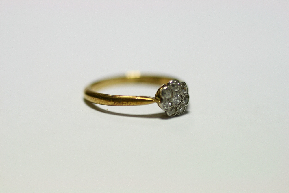 An 18ct. gold & platinum ring set cluster of small diamonds; & a similar ring set row of five - Image 2 of 10