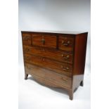 A REGENCY MAHOGANY & BRASS-INLAID SECRETAIRE CHEST, the central secretaire drawer with fall