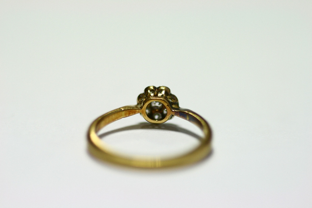 An 18ct. gold & platinum ring set cluster of small diamonds; & a similar ring set row of five - Image 5 of 10