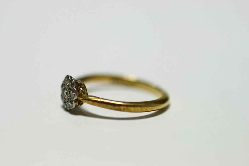 An 18ct. gold & platinum ring set cluster of small diamonds; & a similar ring set row of five - Image 3 of 10