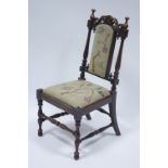 An early Victorian rosewood child’s chair with turned uprights, the padded back & seat upholstered