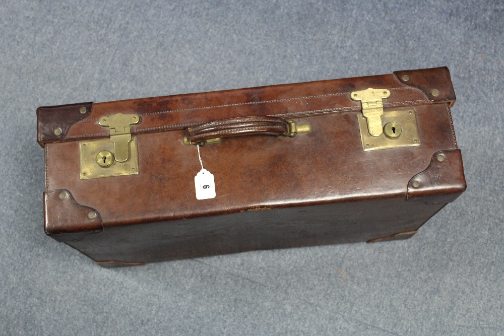 A late 19th/early 20th  century tan leather brass studded suitcase fitted brass twin-lever locks,