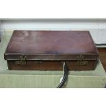 An early/mid-20th century tan leather briefcase with brass twin-lever locks. bears nameplate “
