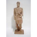 A terracotta standing figure of a French Foreign Legionnaire holding a drum, on square base,