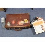 A tan leather suitcase fitted brass twin-lever locks, 24½" x 15" x 7"; a Daily Express volume “The