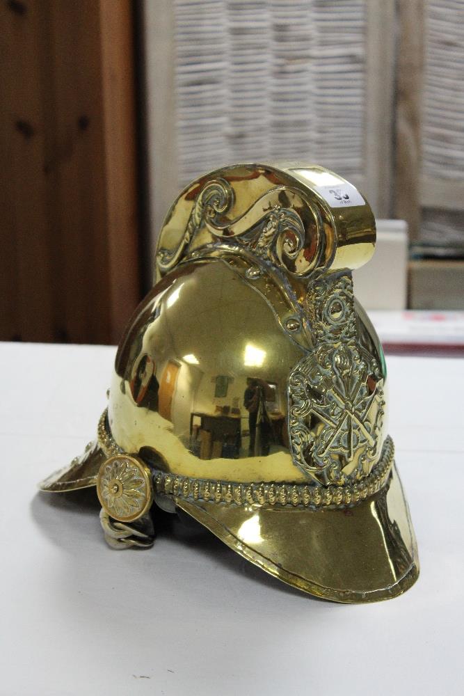 AN EARLY 20th CENTURY BRASS FIREMAN’S HELMET.