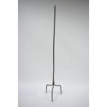 An antique wrought iron floor standing rush-light holder on triform base; 58¾” high.