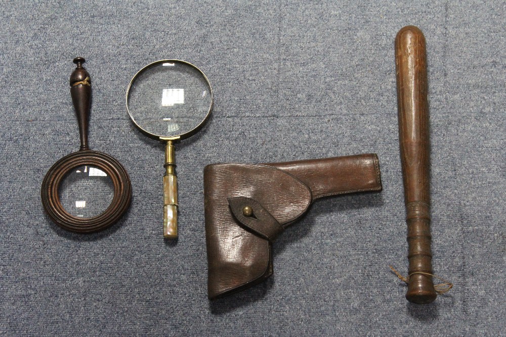 A brown leather pistol holster; a wooden truncheon with turned grip; and two magnifying glasses.