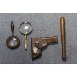 A brown leather pistol holster; a wooden truncheon with turned grip; and two magnifying glasses.
