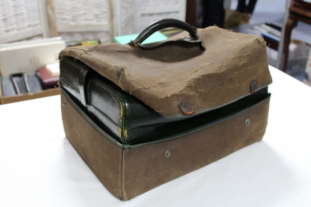 A late 19th/early 20th century dark green morocco leather travelling vanity case, part fitted with