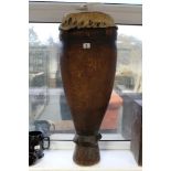 An Ethnic carved hardwood drum of ovoid form & with animal hide skin, 10½" diam. x 32½" high.
