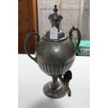 A pewter engraved two-handled samovar of ovoid semi-fluted form, 17" high.
