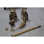 A Wakefield’s of Birmingham coach lamp (1945); another lamp; a Warna bicycle lamp; two oil cans; and