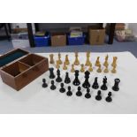 A STAUNTON PATTERN BOXWOOD CHESS SET of black and natural-stained colour (size of Kings 3½" high),