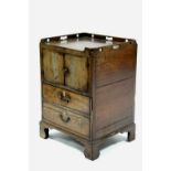 An 18th century inlaid mahogany night commode with pierced tray top, enclosed pair of panel doors,