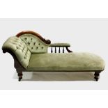 A mid-Victorian carved walnut frame chaise longue with turned spindle arm supports, buttoned