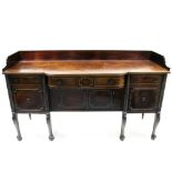 A regency mahogany tray-top sideboard fitted three frieze drawers above four panel doors, on