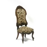 A mid- Victorian carved walnut frame occasional chair with tall padded back & shaped seat, on