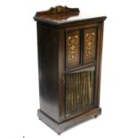 A late Victorian rosewood music cabinet enclosed by a panel door, the upper part with marquetry