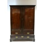 A George III Mahogany wardrobe with moulded cornice, enclosed pair fielded panel doors, fitted