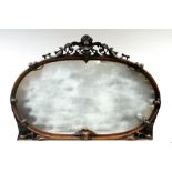 A Victorian oval mirror in carved & pierced walnut frame; 47" wide x 32½" high.