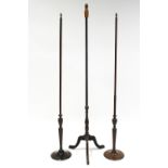 A near pair of 19th century pole screen stands with vase turned columns & circular weighted bases (