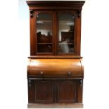 A mid-Victorian cylinder-front bureau bookcase fitted three adjustable shelves enclosed by pair of