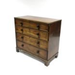 An early 19th century mahogany chest fitted four long graduated drawers with turned knob handles, on