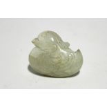 A Chinese carved white jade pendant in the form of a duck; 1¾" wide (chip to tail feather).