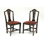 A pair of late 18th century ash dining chairs with pierced splats, padded drop-in seats & on